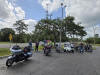 May be an image of 4 people, motorcycle and scooter