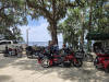 May be an image of 3 people, motorcycle, scooter and text